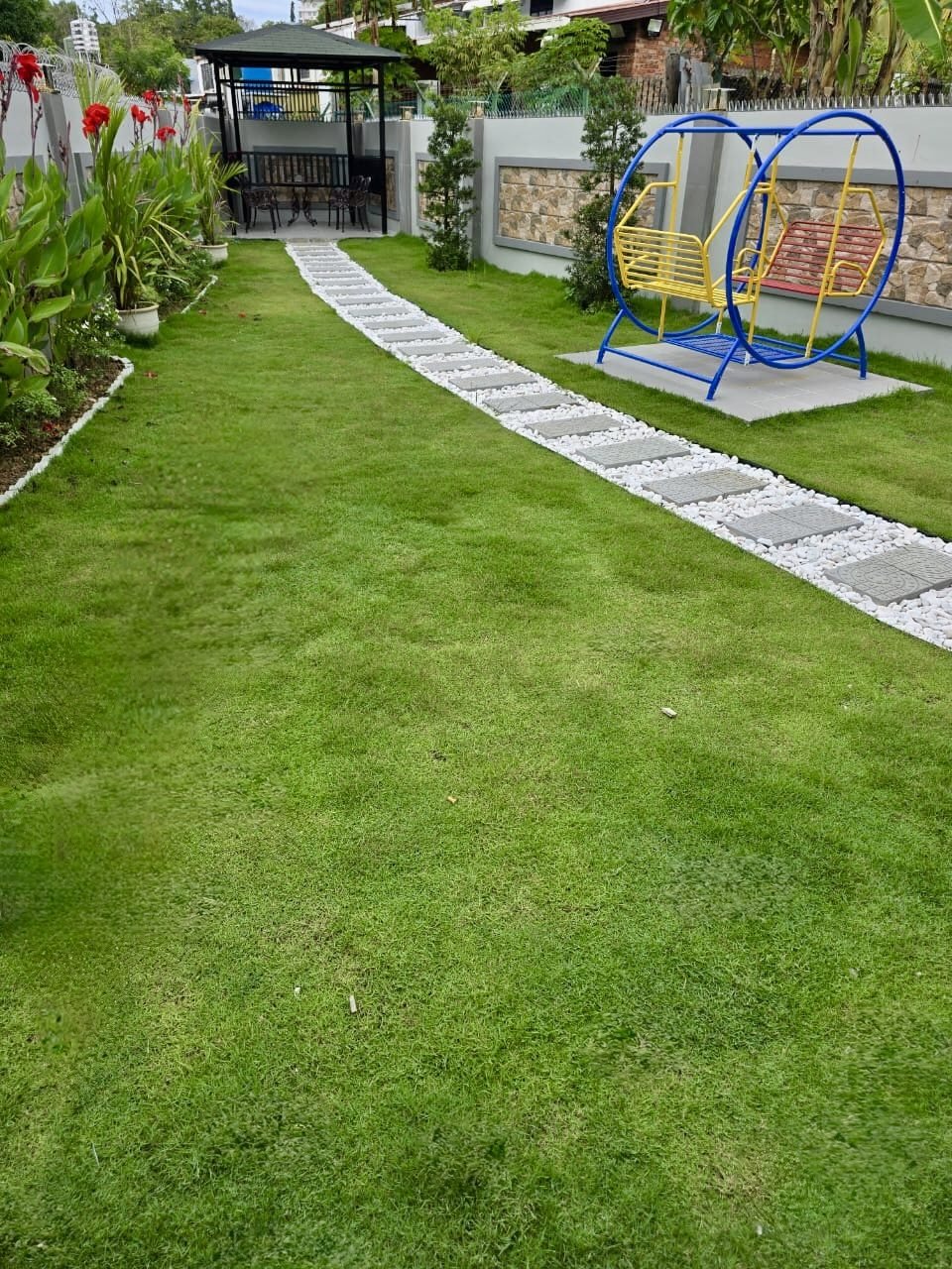 Garden lawn with pathway and swing set